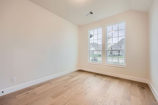 Unfurnished room with baseboards, visible vents, lofted ceiling, and light wood-type flooring | Image 12