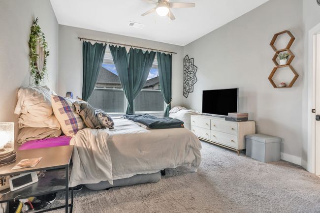 Carpeted bedroom featuring a ceiling fan and baseboards | Image 16