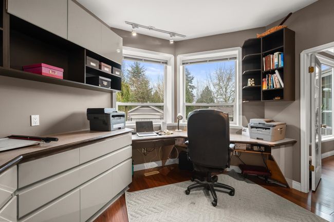 Home office featuring track lighting, baseboards, and dark wood-style flooring | Image 20