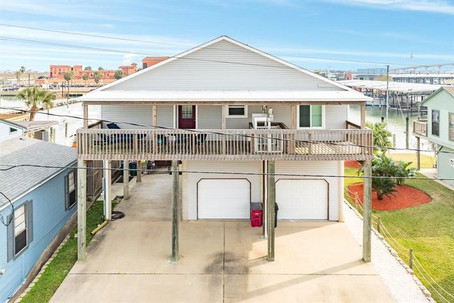 Rear view of 56 Marlin with another spacious deck additional parking and a double garage. Ideal for canalfront living. | Image 25