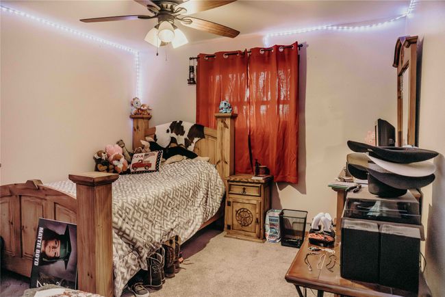 Carpeted bedroom with a ceiling fan | Image 26
