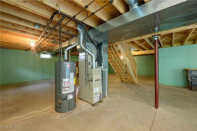 Unfinished below grade area featuring water heater and heating unit | Image 20