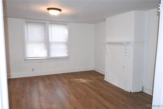 Spare room with baseboards and wood finished floors | Image 13