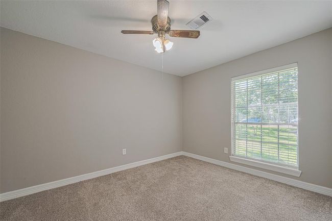 3rd bedroom offers lots of natural lighting from the large window, fan, and ample sized closet | Image 19