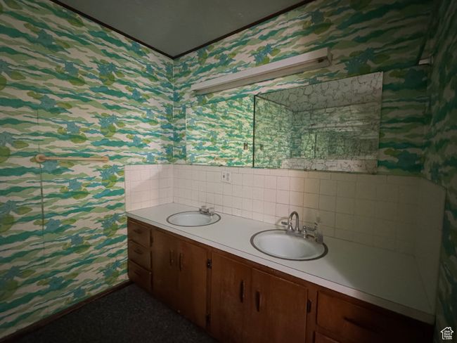 Bathroom with wallpapered walls and double vanity | Image 12