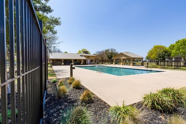Community pool featuring a patio, fence, and a gazebo | Image 38