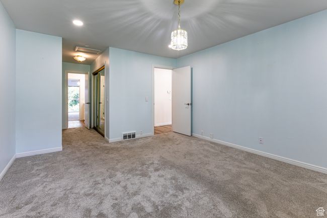 Spare room with carpet floors, baseboards, and a chandelier | Image 21