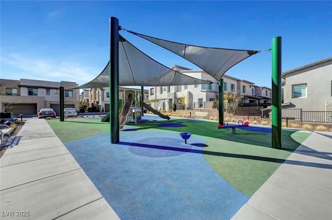 Community play area with fence and a residential view | Image 50