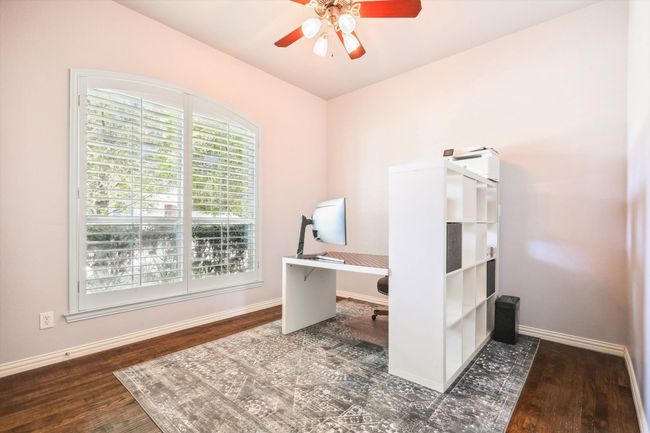 First floor bedroom featuring dark hardwood flooring and ceiling fan | Image 17