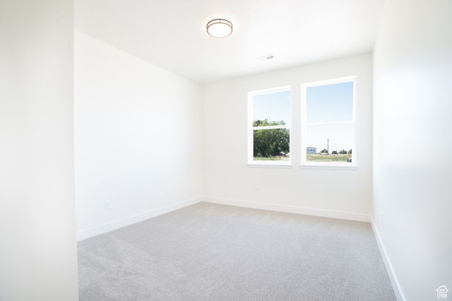 Empty room featuring light colored carpet and baseboards | Image 18