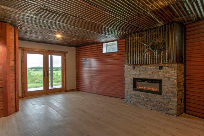 Lower level Family room with electric fireplace and upper TV mount. | Image 21