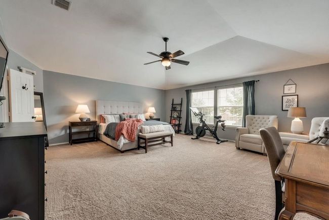 Bedroom with light carpet, vaulted ceiling, and ceiling fan | Image 19