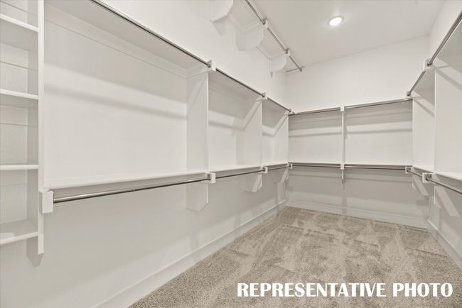 You'll find seasonal hanging racks and plenty of space in this dream closet! REPRESENTATIVE PHOTO | Image 13