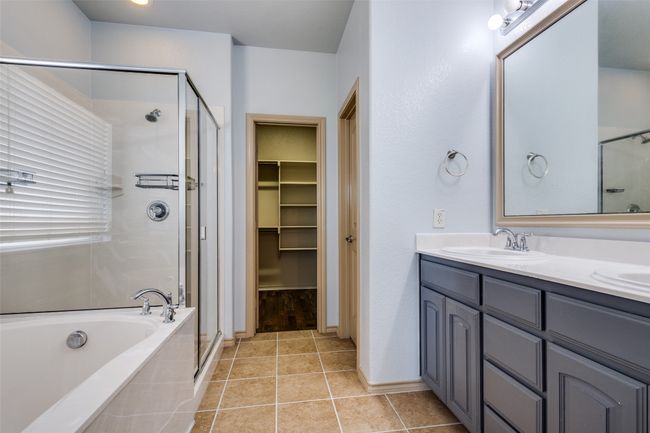 Bathroom with a stall shower, double vanity, a garden tub, tile patterned flooring, and a spacious closet | Image 21