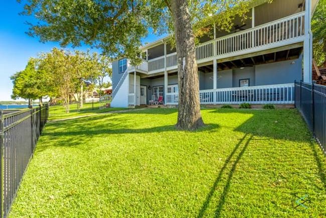Large fenced yard with mature trees. | Image 29