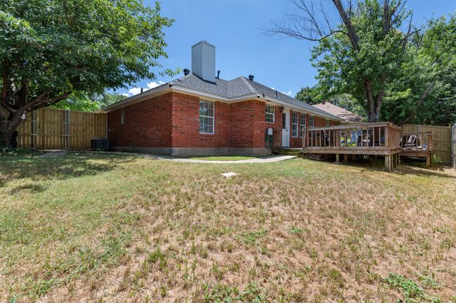 Rear view of property with brick siding, a deck, and a chimney | Image 23
