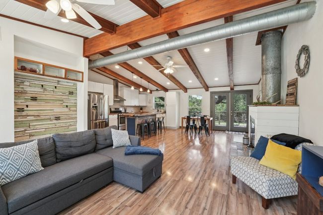 Living room with ceiling fan, light wood finished floors, and recessed lighting | Image 7