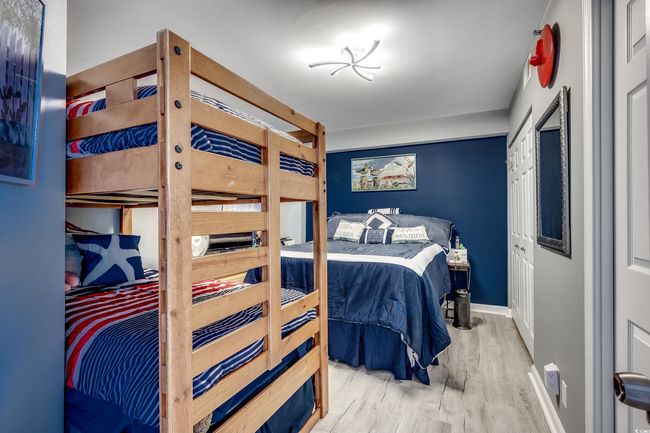 Bedroom featuring wood finished floors and baseboards | Image 21