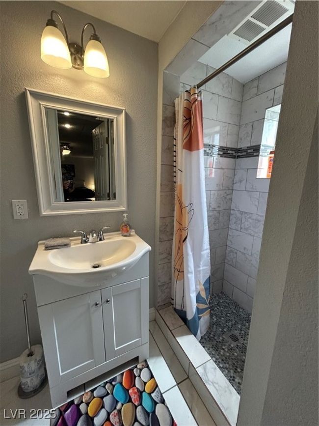 Bathroom featuring vanity and a stall shower | Image 14