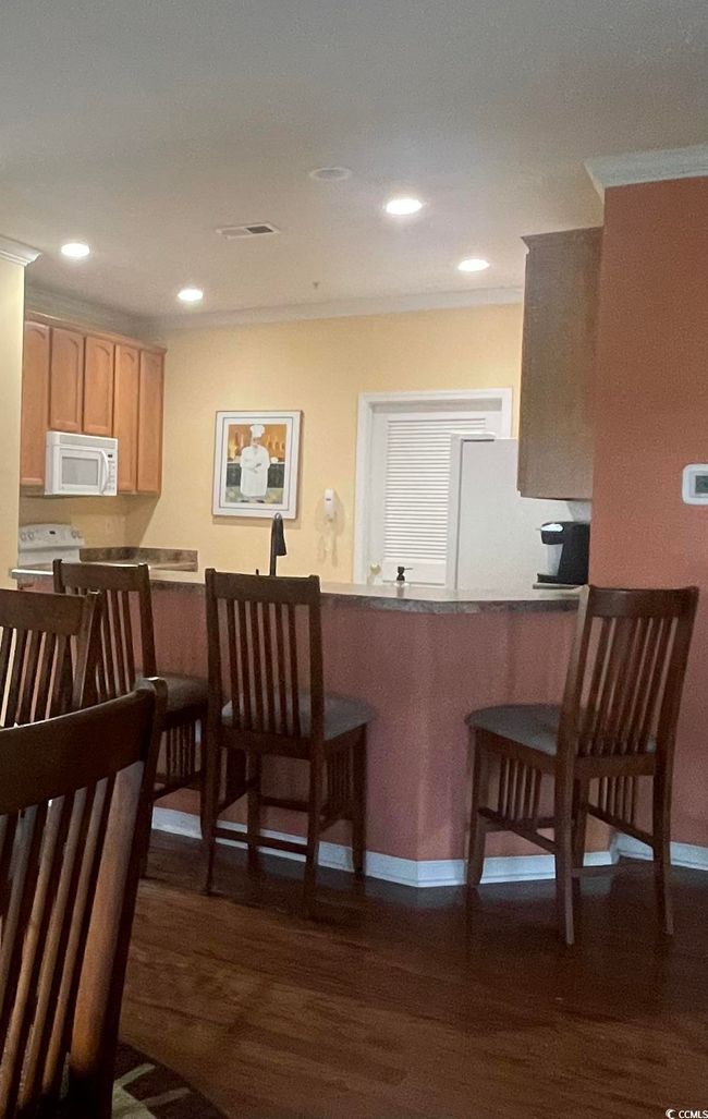 Breakfast Bar has Ample space for eating, Recessed Lighting and Hardwood Flooring. | Image 7