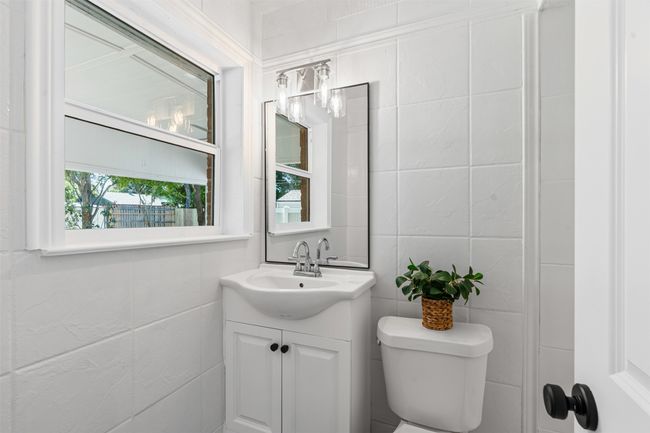 Half bath with vanity and tile​​‌​​​​‌​​‌‌​‌‌​​​‌‌​​‌‌​‌​​​​​‌ walls | Image 22