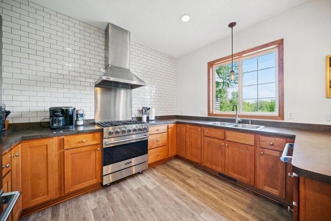 Beautiful kitchen with stainless steel appliances and a classic subway tile backsplash! | Image 12