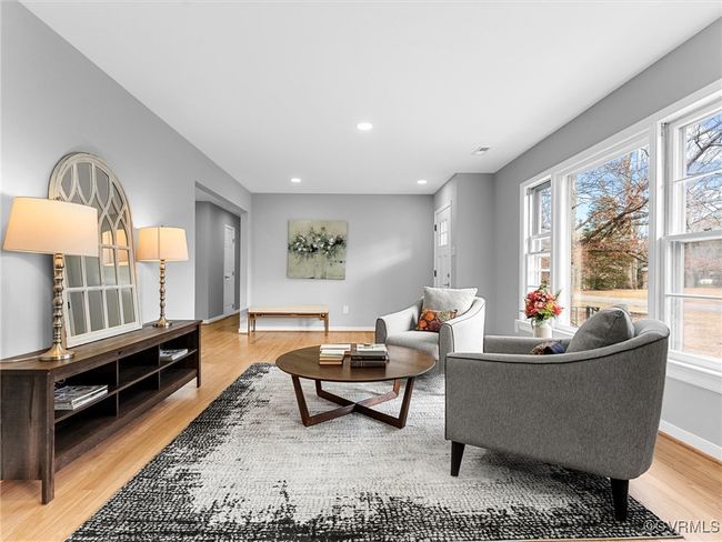Living room with light wood-style flooring, baseboards, and recessed lighting | Image 9