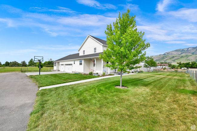 View of front facade featuring an attached garage, driveway, and a mountain view | Image 62