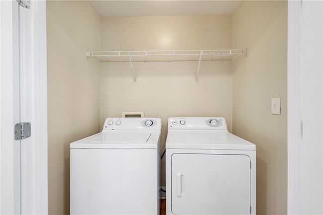 Clothes washing area featuring washing machine and clothes dryer and laundry area | Image 5