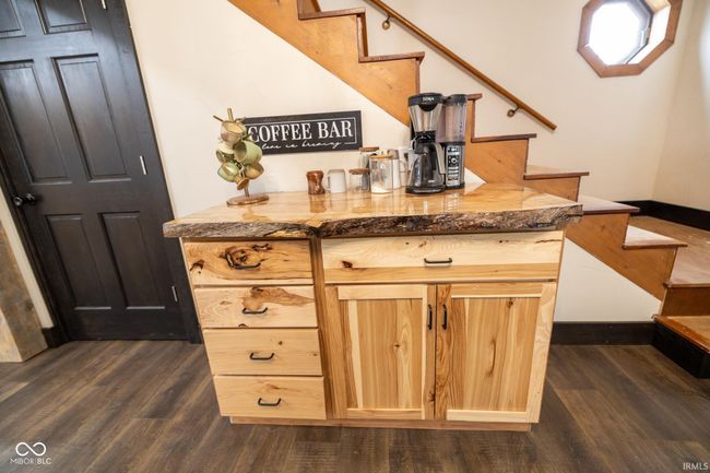 bar featuring stairway, dark wood-style flooring, and baseboards | Image 7