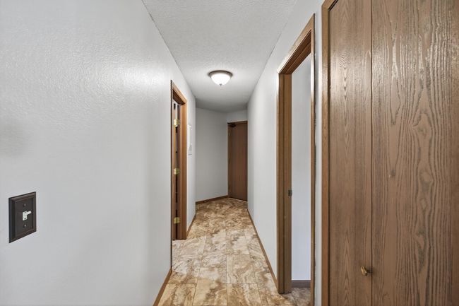 Looking from the dining room to the main entry door you will notice a coat/storage closet on the right. The next door on the right is the primary bedroom and en suite and to the left is the laundry and utility room. | Image 17