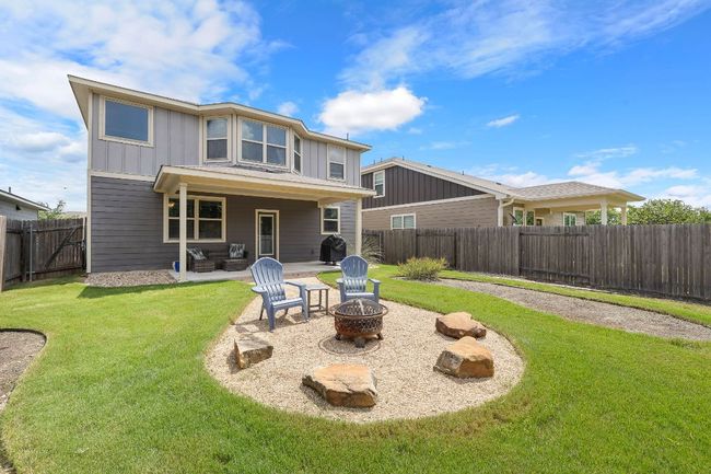 Large covered patio w/ Gas stub for grill, and an outdoor living space with a fire pit | Image 27