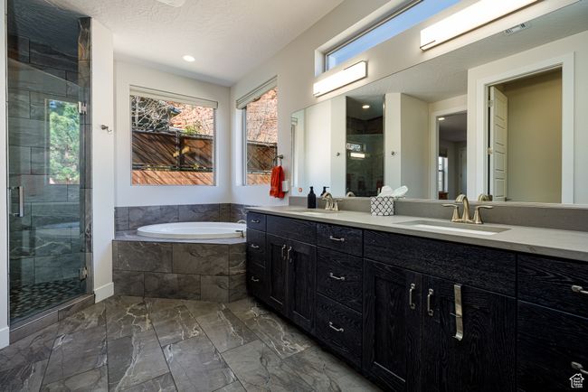 Primary En-Suite Bathroom with a sink, a stall shower, a healthy amount of sunlight, and a bath | Image 21