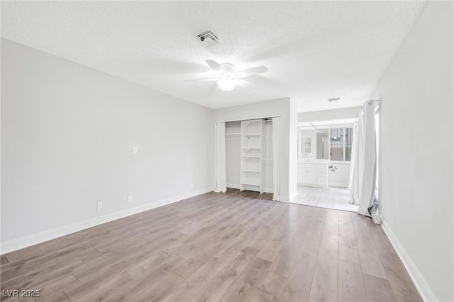 Unfurnished bedroom featuring light wood-style floors, a closet, visible vents, baseboards, and a textured ceiling | Image 17