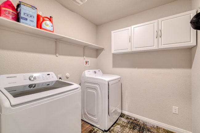 Laundry room with washing machine and clothes dryer, cabinet space, and baseboards | Image 28