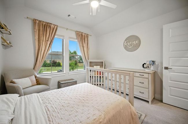 Upstairs Bedroom with light colored carpet, vaulted ceiling, and a ceiling fan | Image 33