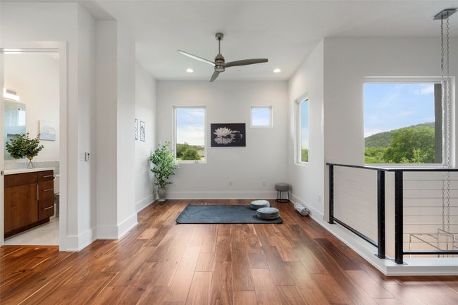 This light-filled flex area offers endless potential—currently styled as a serene exercise room. | Image 30