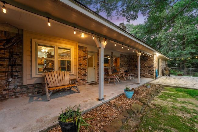 Relax under the covered back porch and enjoy the wildlife. | Image 29