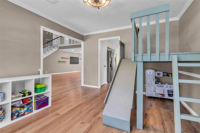 Built-in playhouse features a ladder and slide. | Image 24