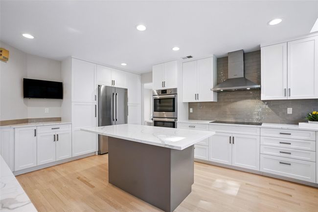There is plenty of room to congregate and sit around the three sided island while keeping the chef company. | Image 10