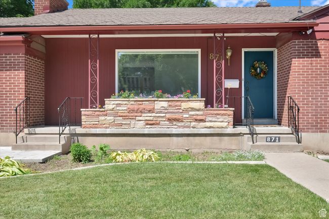 Entrance to property with a chimney, brick siding, a lawn, and a shingled roof | Image 41