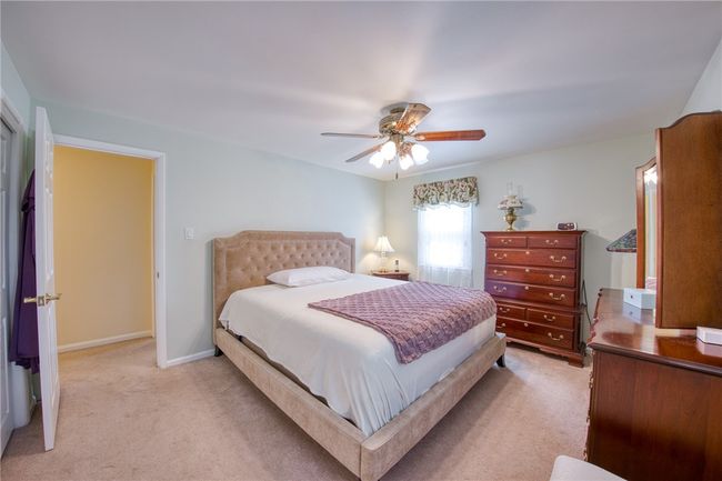 Bedroom with newer carpet and hardwood flooring underneath | Image 22
