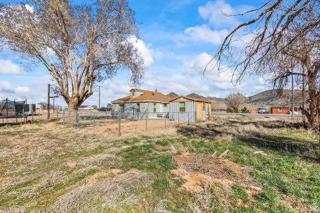 Back of property with a trampoline and a mountain view | Image 24