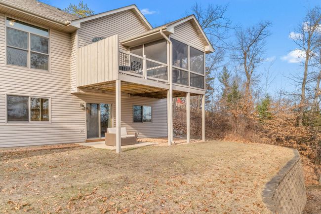 Outdoor entertaining space includes walkout patio, deck, 3 season porch, and open green space. | Image 51