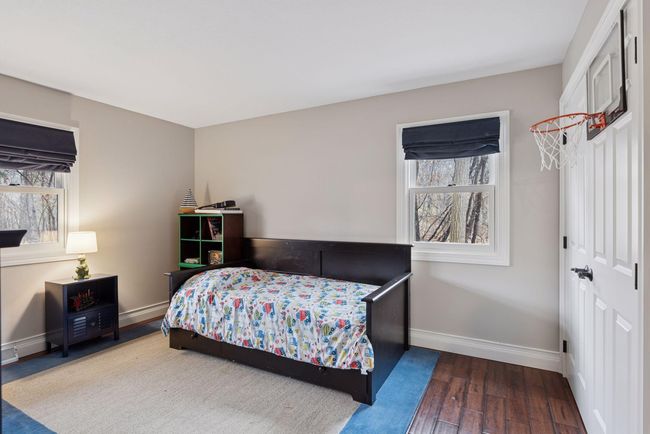 Main floor bedroom has fresh paint and hardwood floors. | Image 21
