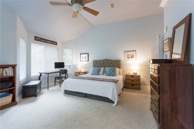 Bedroom featuring vaulted ceiling, light carpet, and a ceiling fan | Image 15