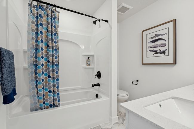 (Photo of a decorated model, actual homes finishes will vary) The third generously sized upper level secondary bedroom with a spacious closet. | Image 16