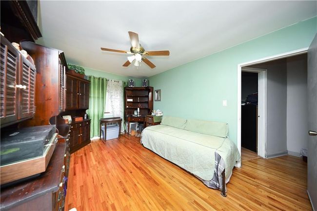 Bedroom with light wood-style floors and a ceiling fan | Image 15