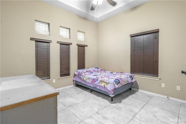 Tiled bedroom featuring ceiling fan | Image 9