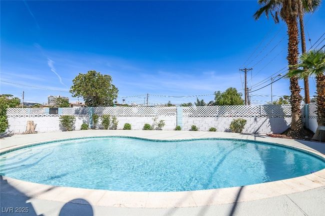 View of swimming pool featuring a fenced backyard | Image 48